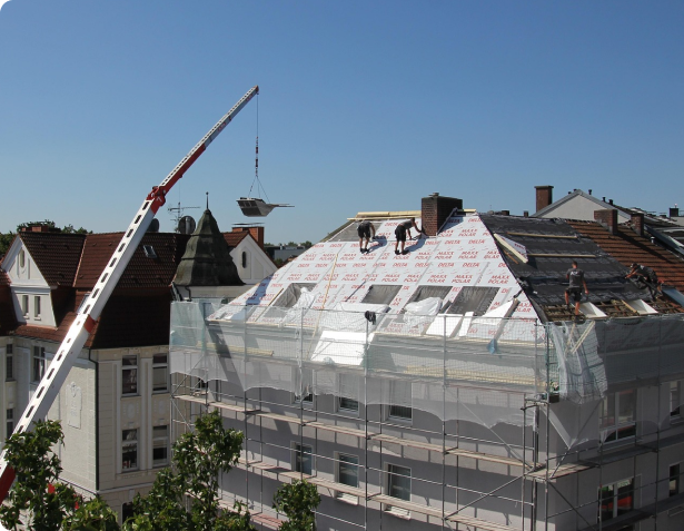 Roofer inspecting a shingle roof